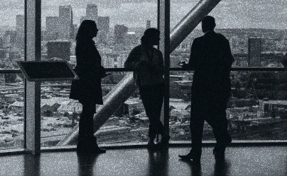 three people speaking by a window
